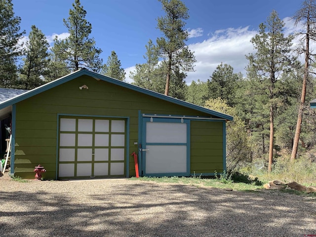 garage with gravel driveway