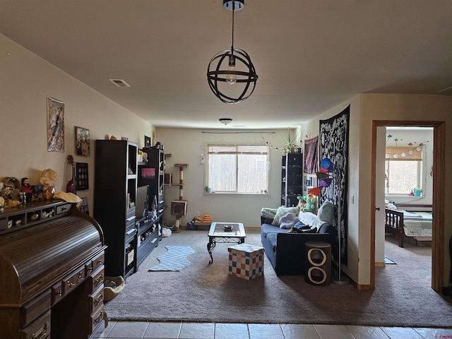 living room with visible vents, carpet flooring, and a wealth of natural light