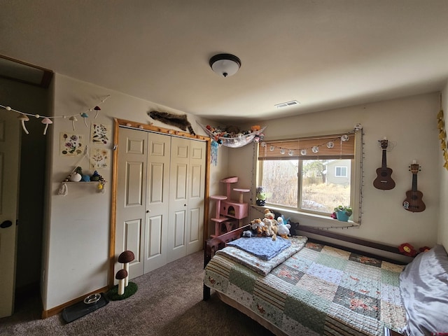 carpeted bedroom featuring visible vents and a closet