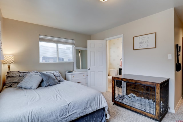 bedroom featuring light carpet, baseboards, and ensuite bathroom