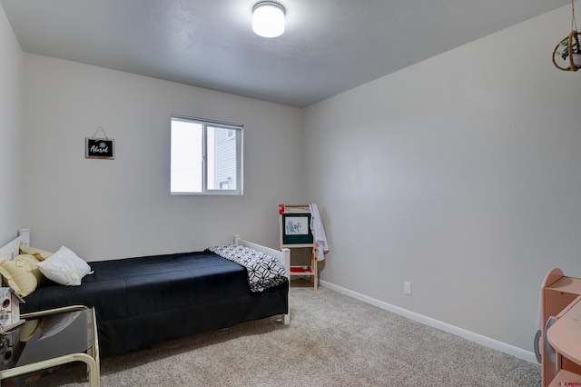 bedroom featuring carpet floors and baseboards