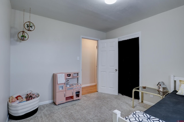 carpeted bedroom with baseboards