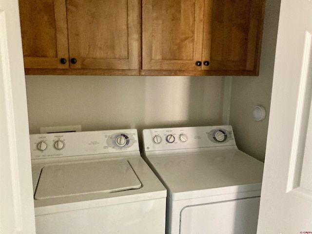 washroom featuring cabinet space and washer and dryer