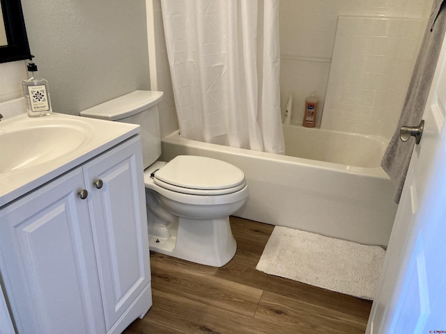 bathroom with shower / tub combo with curtain, vanity, toilet, and wood finished floors