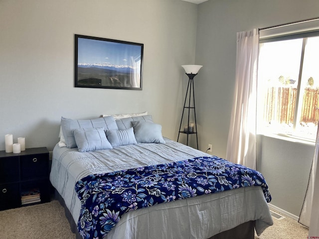 bedroom with multiple windows and carpet