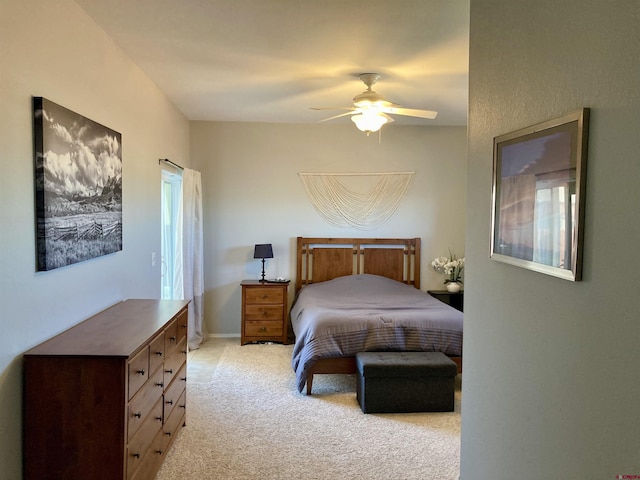 bedroom featuring light carpet and ceiling fan