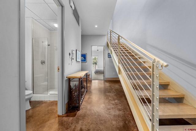 staircase featuring concrete floors