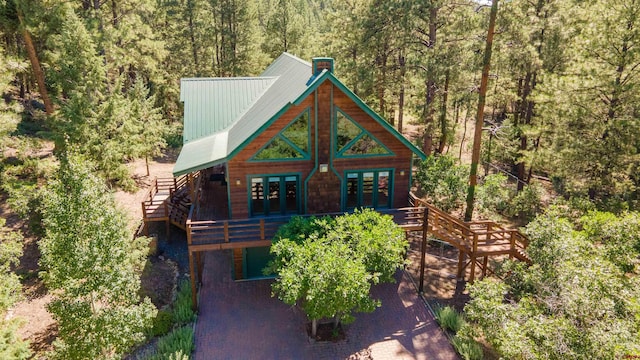 295 Loma Vis, Pagosa Springs, CO 81147 - view of front of house featuring stairs, metal roof, a wooded view, and french doors