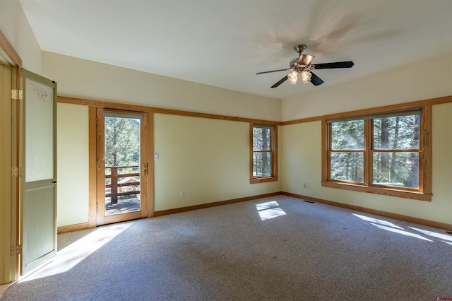 empty room with a ceiling fan, carpet flooring, and baseboards