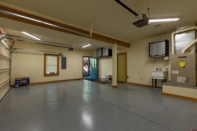 garage with visible vents, a sink, electric panel, and a garage door opener