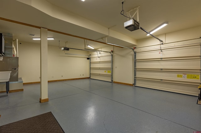 garage with a garage door opener and baseboards