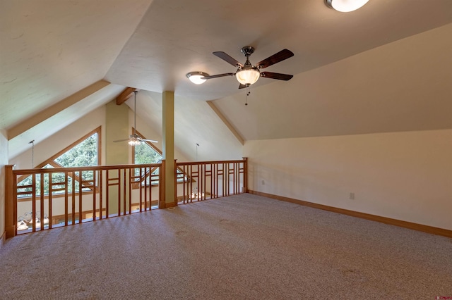 additional living space featuring vaulted ceiling, carpet floors, and baseboards