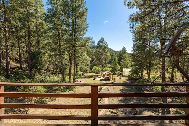 view of gate featuring a view of trees