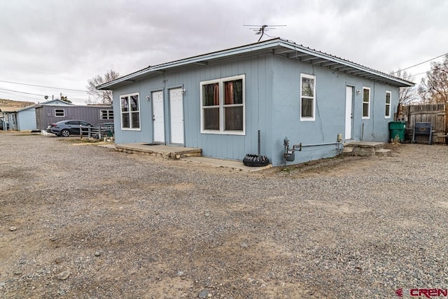 bungalow-style house with fence