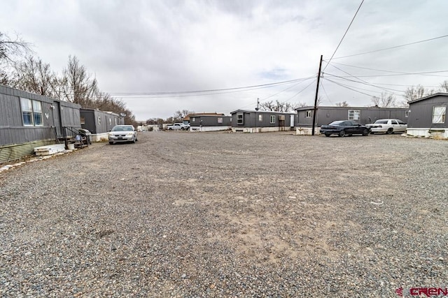 view of car parking featuring a residential view