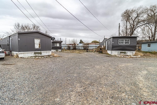 exterior space featuring entry steps and gravel driveway