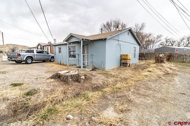 view of side of home featuring fence