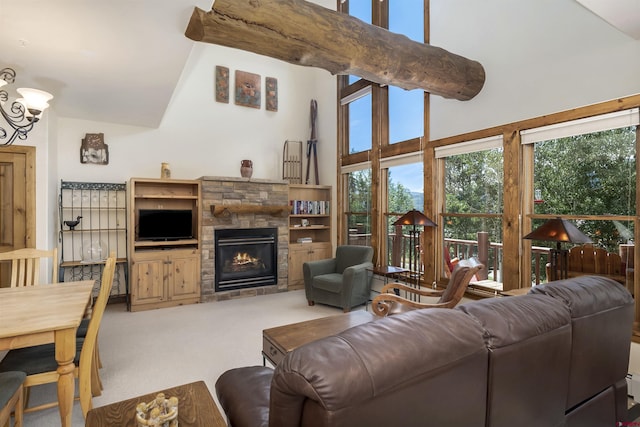 carpeted living area with a stone fireplace and a towering ceiling