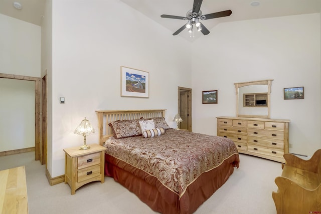 bedroom featuring light carpet, ceiling fan, high vaulted ceiling, and baseboards