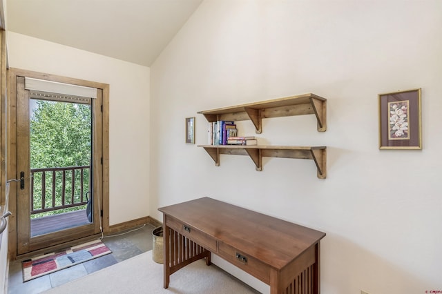 entryway with baseboards and lofted ceiling