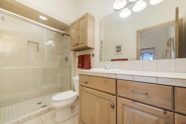 bathroom with tile patterned floors, toilet, a stall shower, and vanity