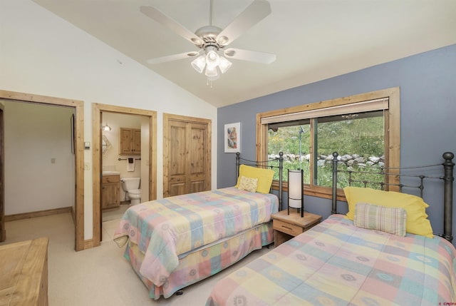 bedroom with baseboards, ceiling fan, lofted ceiling, light carpet, and ensuite bath