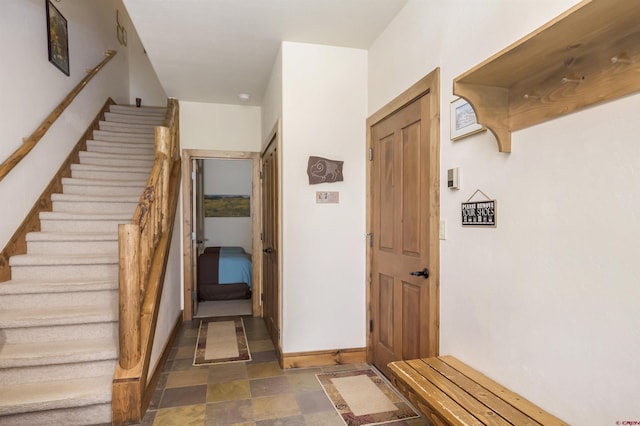 interior space featuring stone finish floor and baseboards