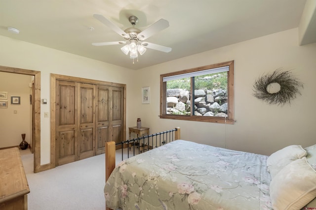 bedroom with a closet, ceiling fan, and carpet