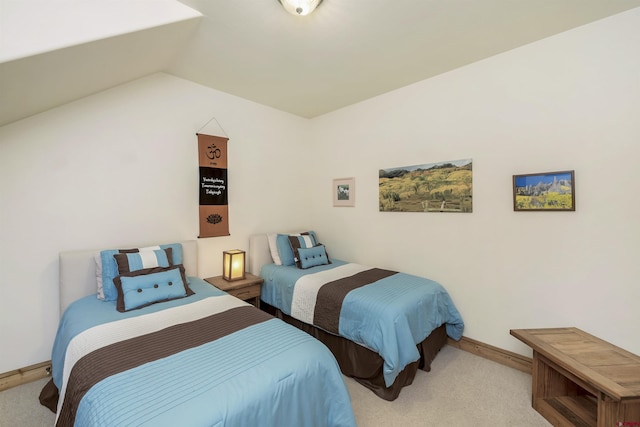 carpeted bedroom with lofted ceiling and baseboards