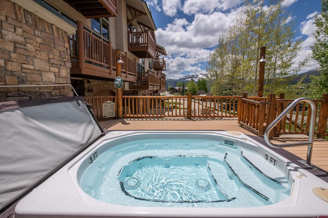 view of swimming pool featuring a deck and an outdoor hot tub