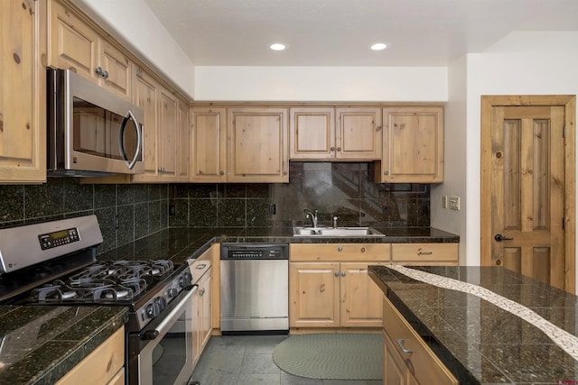 kitchen with tile counters, light brown cabinetry, decorative backsplash, stainless steel appliances, and a sink