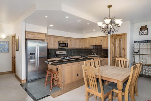 kitchen with backsplash, stainless steel appliances, and dark countertops