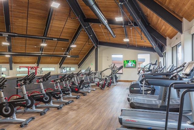 gym featuring wooden ceiling, wood finished floors, baseboards, and high vaulted ceiling