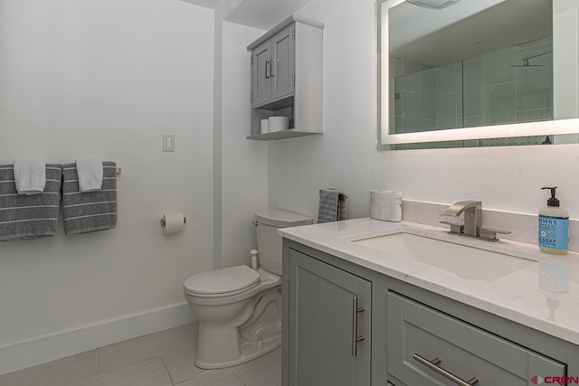 full bath featuring walk in shower, baseboards, toilet, tile patterned floors, and vanity