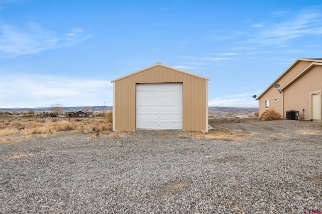 detached garage featuring central air condition unit