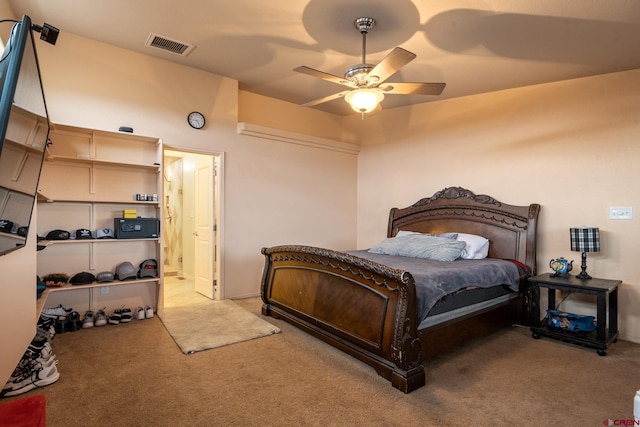 bedroom featuring ceiling fan, visible vents, carpet floors, and connected bathroom