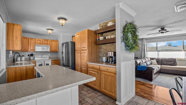 kitchen with visible vents, white appliances, light countertops, and a sink