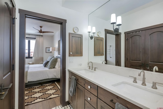 full bathroom featuring ceiling fan, ensuite bath, wood finished floors, and a sink