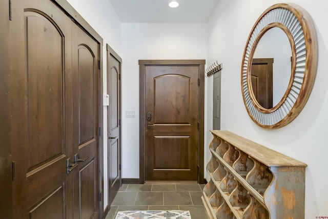 doorway with tile patterned floors, baseboards, and recessed lighting