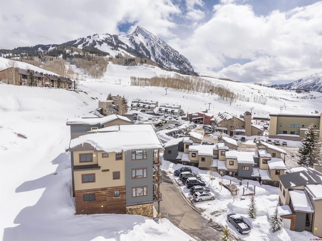 snowy aerial view featuring a mountain view