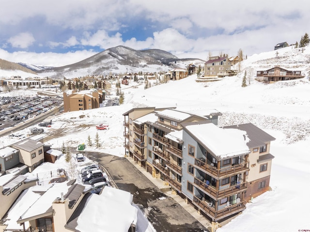 snowy aerial view with a mountain view