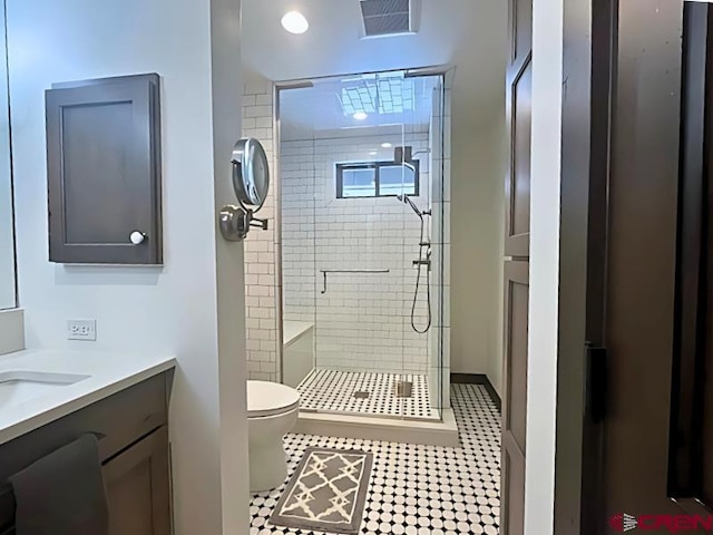 full bath with visible vents, a stall shower, toilet, and vanity