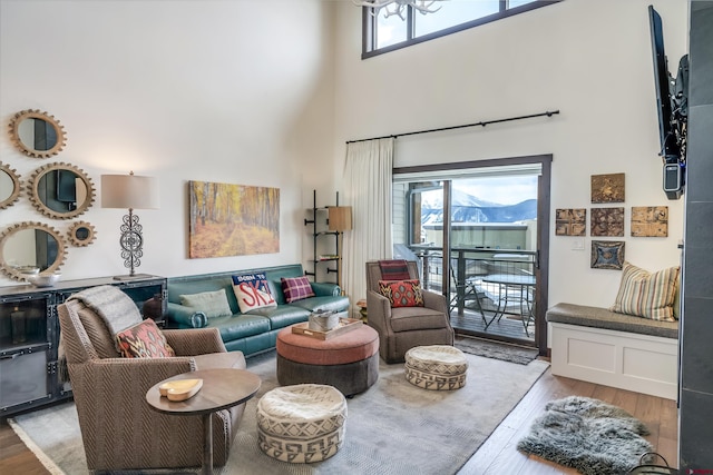 living room with a high ceiling and light wood-style floors