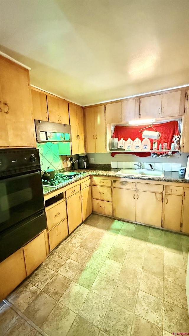 kitchen featuring oven, extractor fan, white gas cooktop, decorative backsplash, and a sink