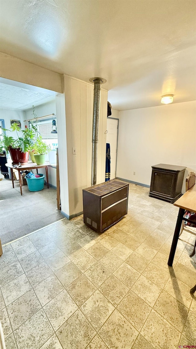 living area featuring baseboards and a textured ceiling