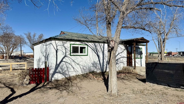 view of outbuilding featuring fence