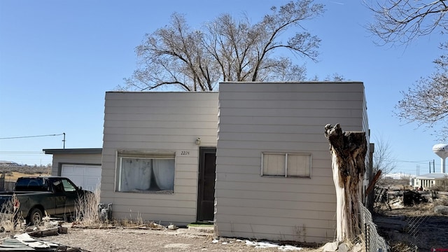 rear view of property with a garage