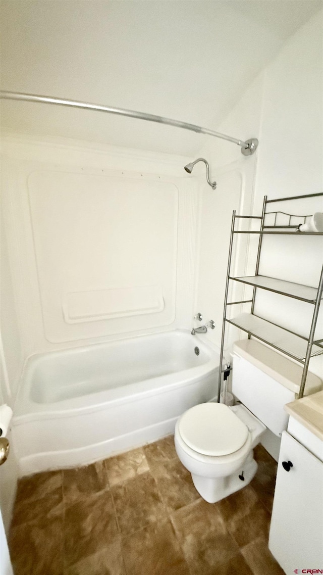 bathroom featuring toilet, vanity, and bathtub / shower combination