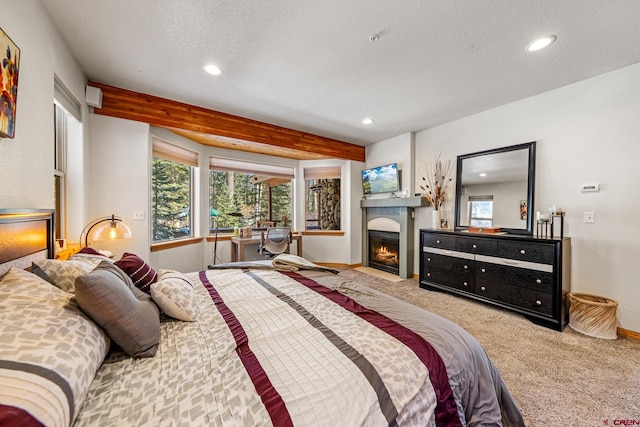 bedroom featuring baseboards, a fireplace with flush hearth, carpet flooring, recessed lighting, and a textured ceiling