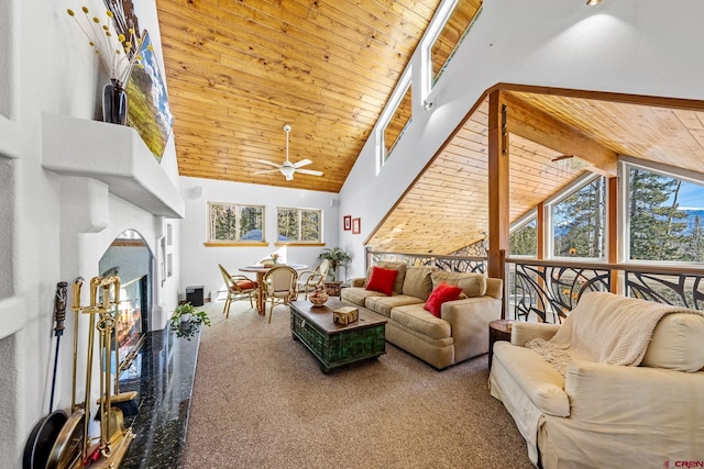 sunroom featuring a glass covered fireplace, wooden ceiling, vaulted ceiling with beams, and ceiling fan